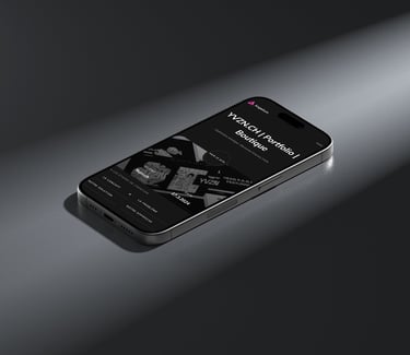 An iPhone displaying the YVZN website on its screen.