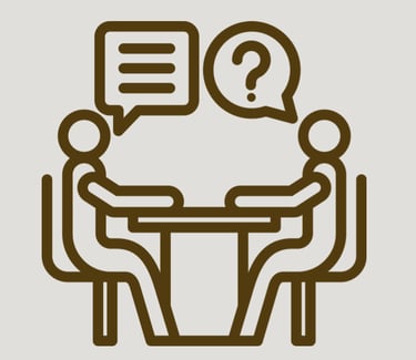 Picture of OT and participant at a table learning asking questions and learning together