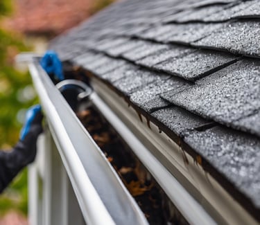 a man in a yellow vest is cleaning the floor