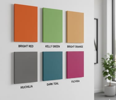 Six colorful acoustic wall panels in red, green, orange, grey, teal, and fuchsia on a white office wall.
