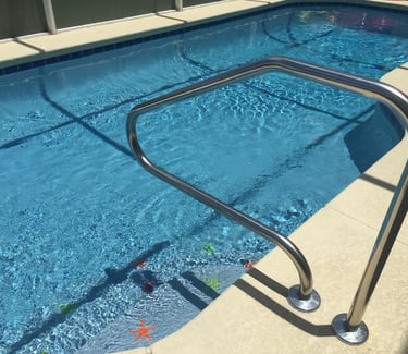 a swimming pool with a metal handrail in Florida