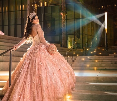 a woman in a pink quinceanera dress and umbrella