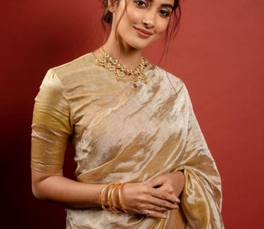 Pooja Hegde wearing a golden silk saree and traditional jewelry for an ethnic fashion shoot.