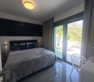 Villa Fay bedroom with a bed and a table with chairs on terrace