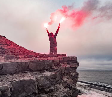 Survivor holding red flare near cliffside, emergency rescue signaling and coastal survival situation