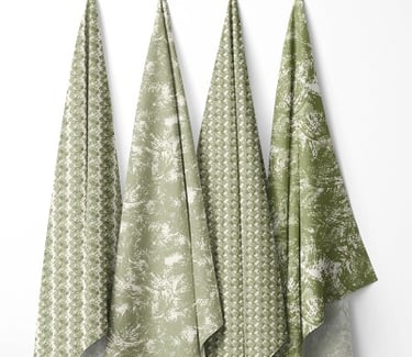 ssorted green textile samples with geometric and botanical patterns, displayed side by side on a white backdrop