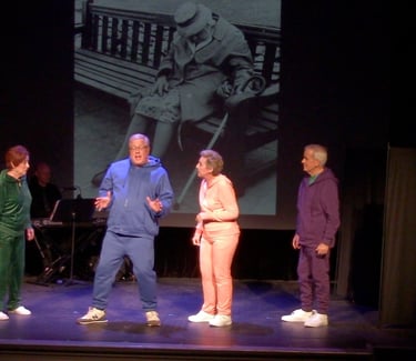 Senior actors performing a stage play in colorful tracksuits with a vintage photo backdrop.