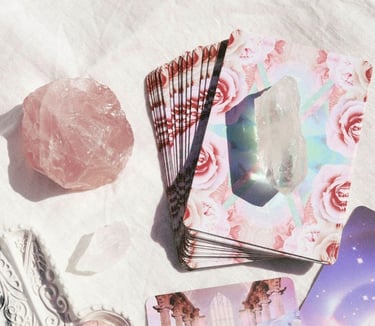 Tarot accessories featuring stack of tarot cards and crystals on a table.