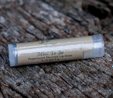 tube of lip balm on a tree stump
