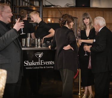 Guests enjoying drinks at a Shaken Events mobile cocktail bar during a professional corporate event