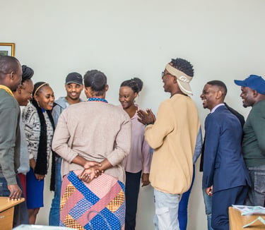 a group of people standing around happily having a discussion