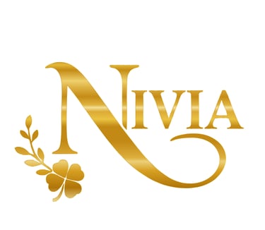 Elegant gold Nivia brand logo featuring a serif typeface with a metallic gradient and a four-leaf clover accent.