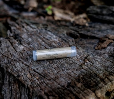 tube of lip balm on a tree stump