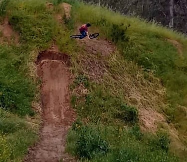 Rider turning mid-air on a hip jump, angling sideways