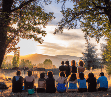 a group of people sitting on a hill