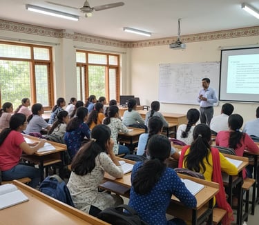 Teacher explaining C programming concepts to students in a classroom with projector