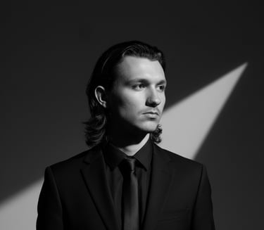 a man in a suit and tie with a black tie
