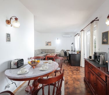 The photo shows an open-plan dining and living room.