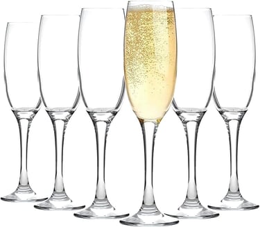 a row of wine glasses with champagne in front of a white background