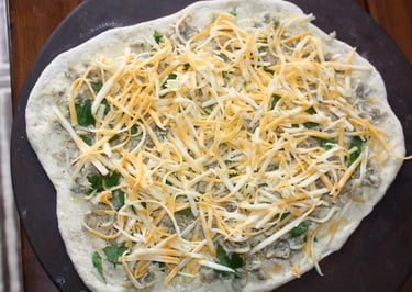 clam pizza with cheese before being cooked