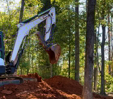 mini-excavator-digging-dirt.png