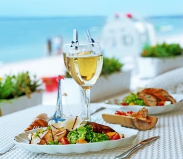 a table with a glass of wine and food