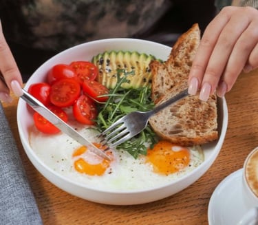 a person eating a bowl of food with a fork and fork
