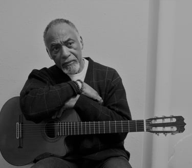 Late actor William S Taylor holding a guitar while filming a scene in Coco Blue