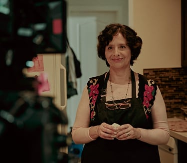 Actress Magda Ochoa smiling to the camera in a scene of Lupe Q and the Galactic Corn Cake