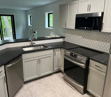 Annick Building Services a Custom kitchen with a stove top oven and a microwave