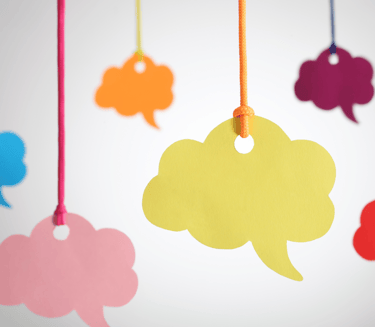 a bunch of colorful speech bubbles hanging from a string