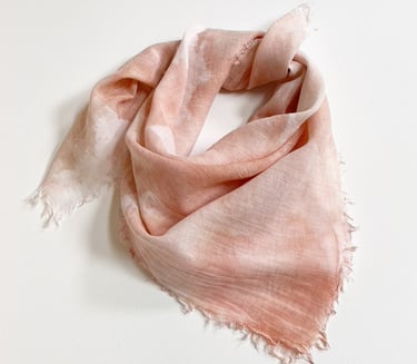 Soft, lightweight pink cotton bandana with raw fringed ends displayed on a plain white background