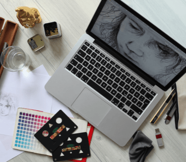 a laptop computer sitting on a table with a laptop and a notebook