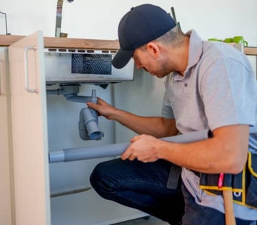 Plumber fixing a bathroom sink