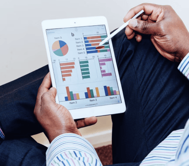 a man inspecting a tablet containing metrics
