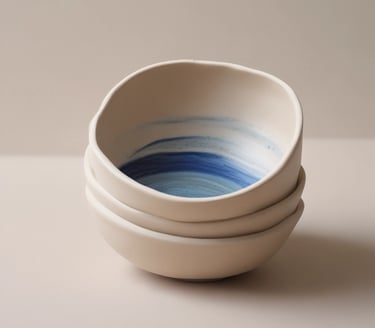 Close-up of handcrafted sea-inspired ceramic decor pieces arranged on a rustic wooden table.