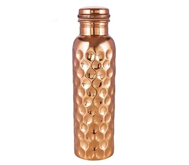 a small copper vase with a gold colored glass jar