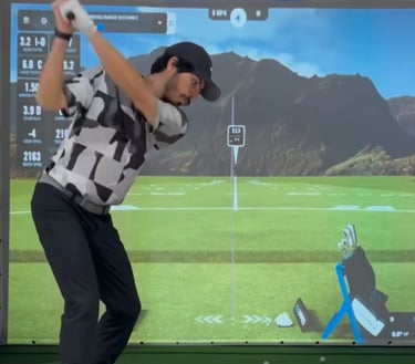 a man playing golf on a golf simulator