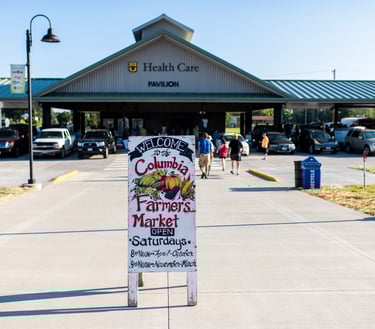 Photo taken of the Columbia Farmer's Market sign in front of the Farmer's Market pavilion