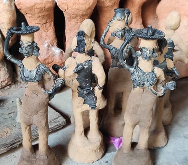 "Handcrafting tribal brass art: Layering fine clay over detailed wax mould in Bastar's Dhokra technique"