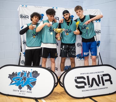 A winning youth basketball team posing with a gold trophy and medals at an SWR sports event.