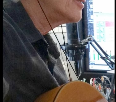 Bob Bushnell playing guitar in a recording studio