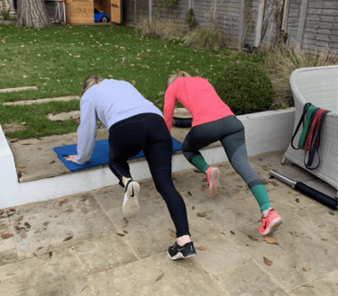 Clients working through a personal training workout in Robb Sheridan’s Lightwater home gym.