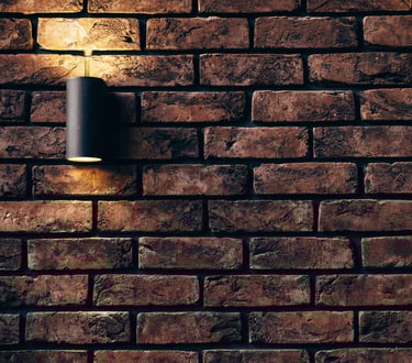 a brick wall with a light installed by pbp services in worcester