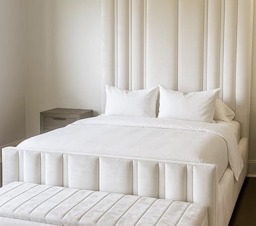 Bedroom with vertical upholstered wall panels in a soft neutral tone by Solo Home Decor