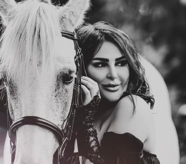 Black and white portrait of model with white horse, captured by Fred Art Studio.