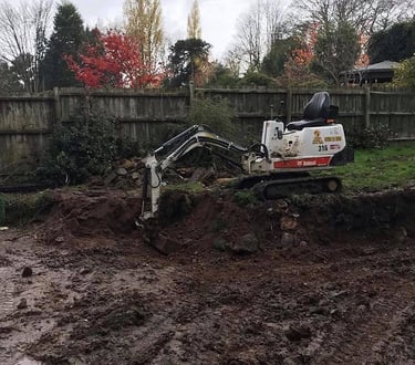 Mini digger excavating trench in Selly Oak garden