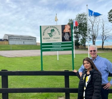 a man and woman standing in front of a sign