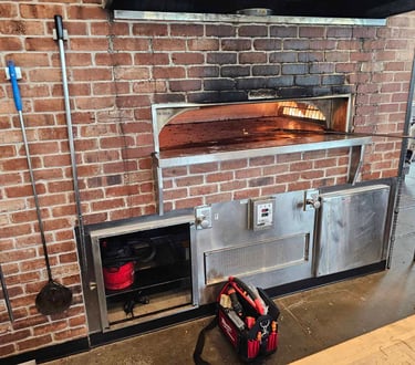 appliance repair technician is replacing control board in commercial oven