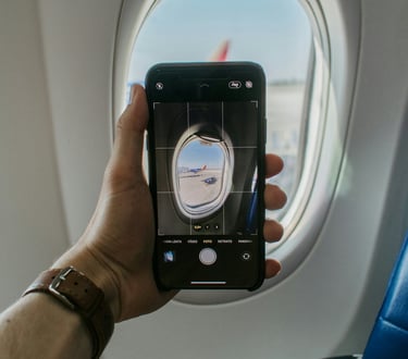 A person taking a photo in airplane